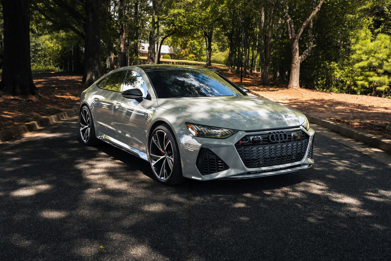 Grey Audi RS7 Sportback parked in dappled shade