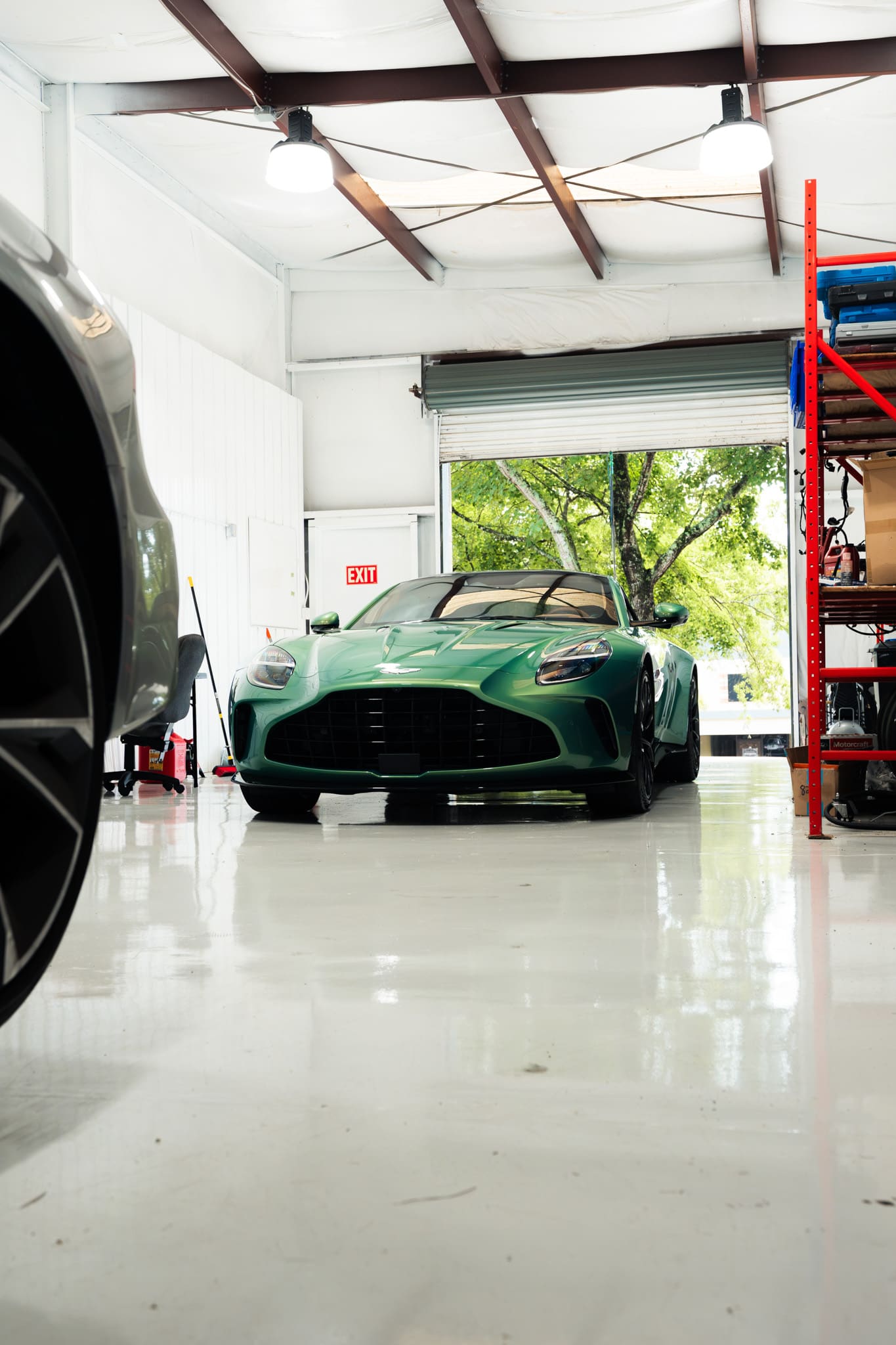 Green Aston Martin Vantage inside the Eurocharged Atlanta shop, seen low from across the floor